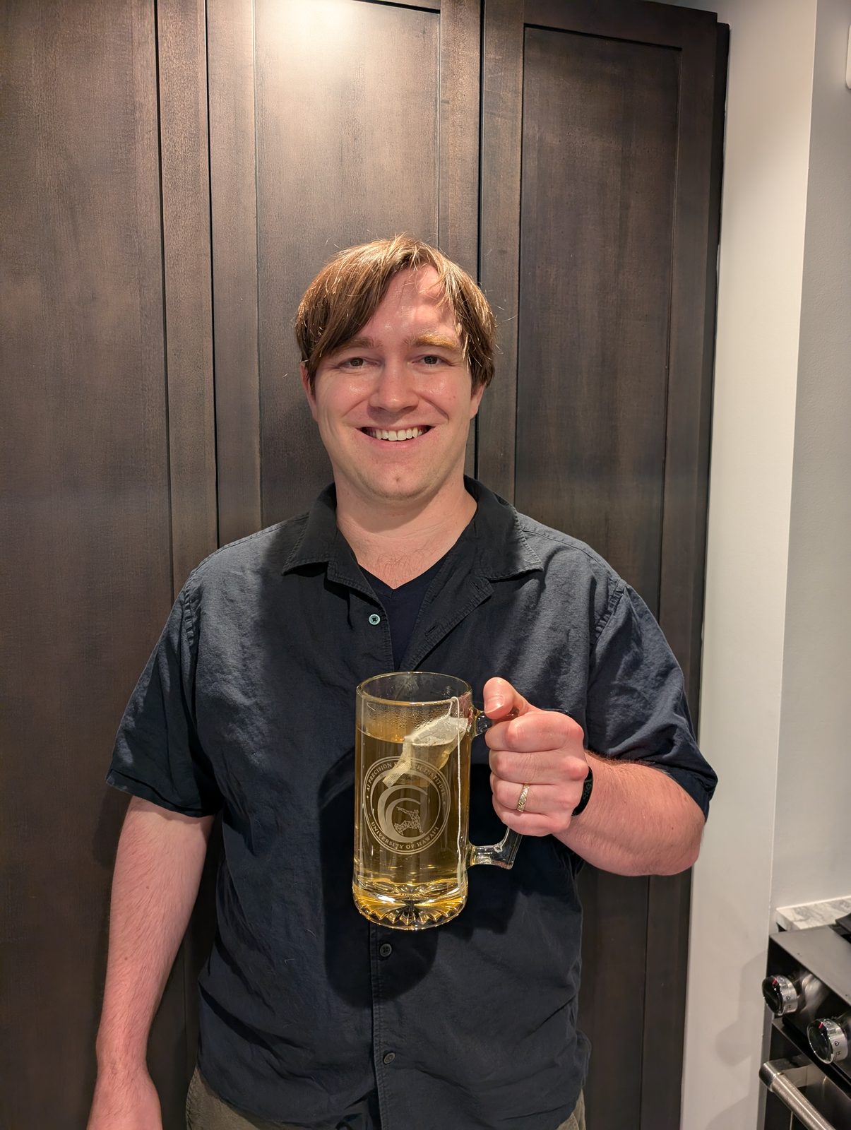 Matthew B. A. McDermott with their PAC-AID beer stein